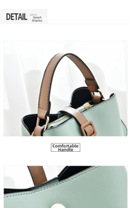 Detail of comfortable brown handle with gold metal rings on light green leather bag