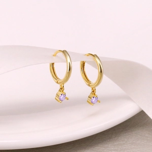 Detail view of S925 silver gold-plated hoop earrings with purple round zircon pendants