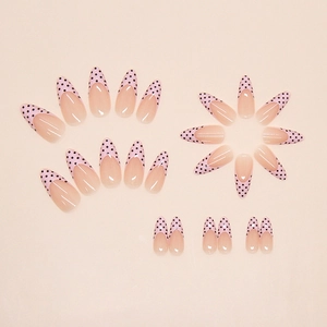 Pink French almond press on nails with elegant black polka dots and a glossy finish