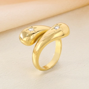 Macro view of golden stainless steel ring with teardrop ends and star-set crystal