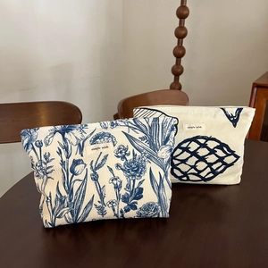 Close-up of floral and geometric print canvas makeup bags with 'simple wish' label
