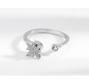 Detail of silver spinning snowflake ring with zircon stars and adjustable open band