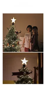 Close-up of glowing star tree topper with rotating reindeer sleigh and Merry Christmas banner