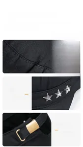 Detail of black cotton flat top cap with metal stars and adjustable buckle strap