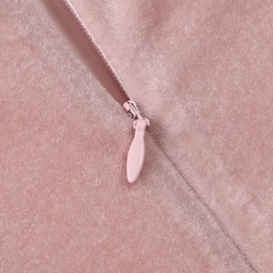 Close-up of pink velvet dress showing soft texture and a seamless invisible zipper detail