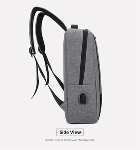Side view of gray minimalist backpack showing external USB charging port and oxford fabric