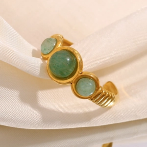 18K gold plated stainless steel ring featuring three green aventurine stones on white fabric