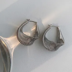 Minimalist silver twist U-shaped earrings featuring textured wire winding and metallic finish