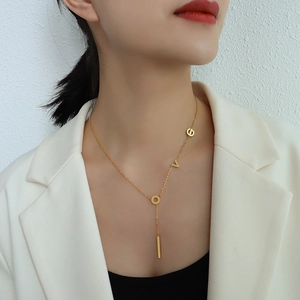 Gold 18k plated LOVE pendant necklace with long vertical bar drop charm on female model