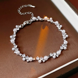 Irregular pearl and zircon geometric bracelet in silver, displayed on a luxury jewelry box