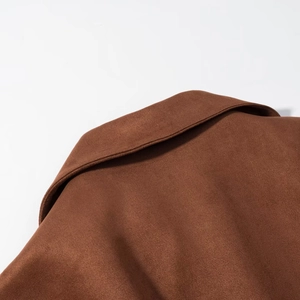 Close-up of lapel and stitching detail on brown faux suede double-breasted jacket