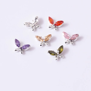 Macro shot of 3D butterfly nail charms with marquise zircon stones in six vibrant colors