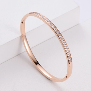 Minimalist rose gold bracelet with CNC inlaid rhinestones on white geometric background