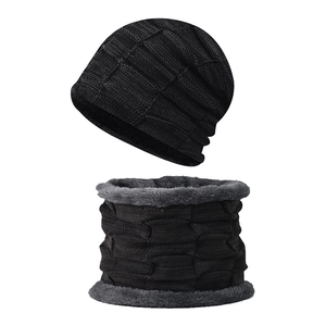 Close-up of black knitted hat and neck warmer set with thick gray fleece lining