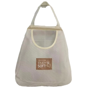 Wall-mounted mesh storage bag in cream white for onions and ginger storage