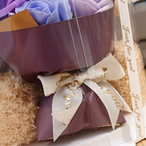 Detail of purple soap roses and brown teddy bears tied with a Just for you ribbon