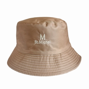 Close-up of khaki bucket hat featuring detailed M St. Michel embroidery and twill texture