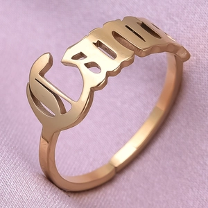 Detail of adjustable gold ring featuring a custom hollow Emily nameplate design
