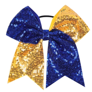 Détail du nœud à paillettes bleu et or pour filles avec élastique à cheveux durable