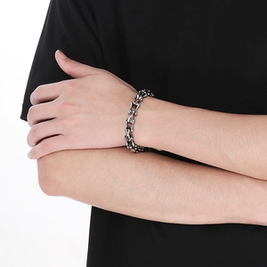 Detailed view of punk skeleton bone link bracelet in vintage silver on a male wrist