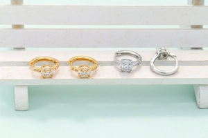 Detailed macro view of gold and silver heart earrings with micro-pave zirconia settings
