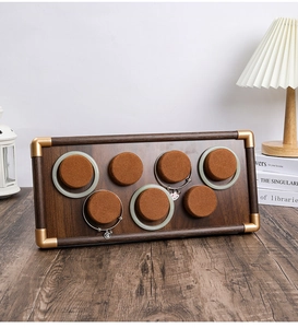 Detail of walnut wood jewelry tray with 7 slots for bracelets and golden corner guards