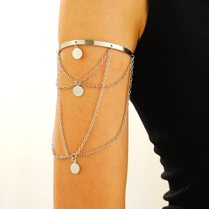 Polished silver arm cuff featuring layered metal chains and round fringe charms