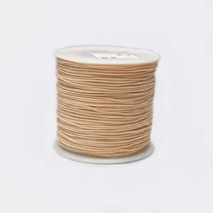 Detailed close-up of 0.8mm beige braided cord on a white spool for jewelry making