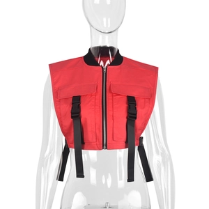 Detail of red tactical utility vest featuring black buckles and functional zipper closure