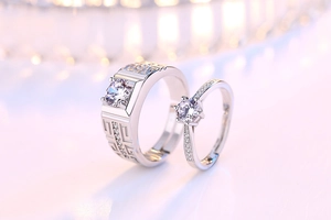 Detail of adjustable silver couple rings featuring classic geometric patterns and inlaid zircons