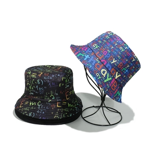 Close-up detail of colorful Happy Birthday print and physics formula pattern bucket hats
