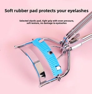 Macro shot of polished stainless steel eyelash curler with blue elastic silicone pad
