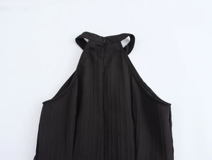 Close-up of elegant black halter neckline showing fabric texture and shoulder design details