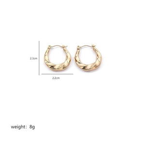 Detailed view of twisted golden C-shape earrings with dimensions 2.3cm by 2.2cm