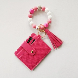 Pink silicone bead bracelet with woven card wallet, gold keychain and fringe tassel