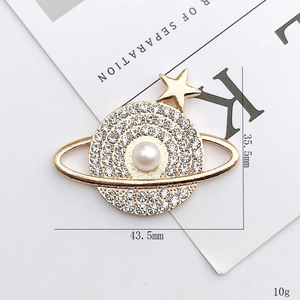 Sparkling Saturn planet brooch with rhinestones and pearl detail, 35.5mm by 43.5mm size