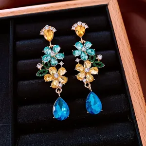 Luxurious floral tassel earrings with colorful crystals and blue teardrop charms