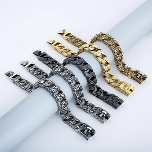 Detail of gothic skull cuban link bracelets in gold, black and silver stainless steel