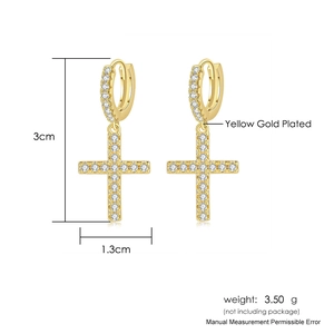 Detail of yellow gold plated cross earrings with white zircon and 3cm height specifications