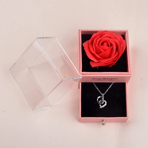 Pink jewelry gift box featuring a red rose and a silver heart necklace with acrylic cover