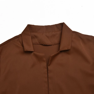 Close-up of the brown shirt collar showing fine stitching and smooth fabric texture