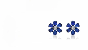Detail of S925 sterling silver daisy earrings featuring pear-cut aquamarine stones