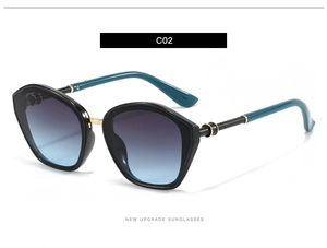 Detail of polygon sunglasses with blue-purple gradient lenses and gold bridge