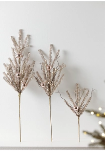 Three-piece champagne gold Christmas picks with pink baubles on white wall