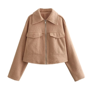 Detail of camel tweed jacket with metal zipper closure and large front flap pockets