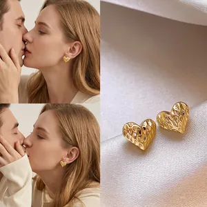 Golden heart-shaped earrings with hammered texture finish, celebrity style fashion jewelry