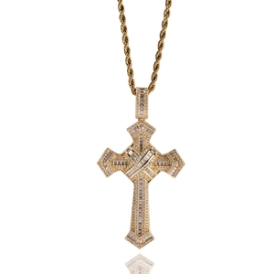 Macro detail of gold-plated cross pendant with cubic zirconia and rope chain necklace