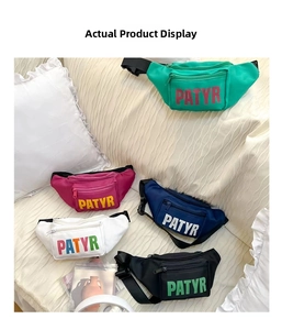 Detailed view of colorful fanny packs in green, pink, and blue with bold letter prints