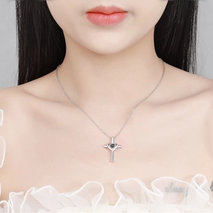 Silver cross projection necklace with custom photo stone worn by a model on collarbone