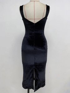 Detail view of the black velvet bodycon dress featuring a rear zipper and split hemline
